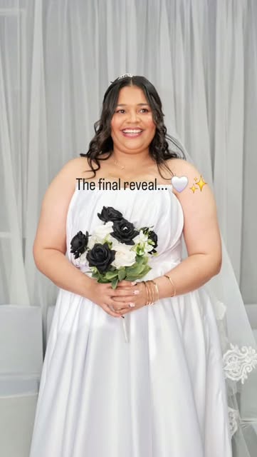 Bride holding a black-and-white bouquet after her makeup reveal