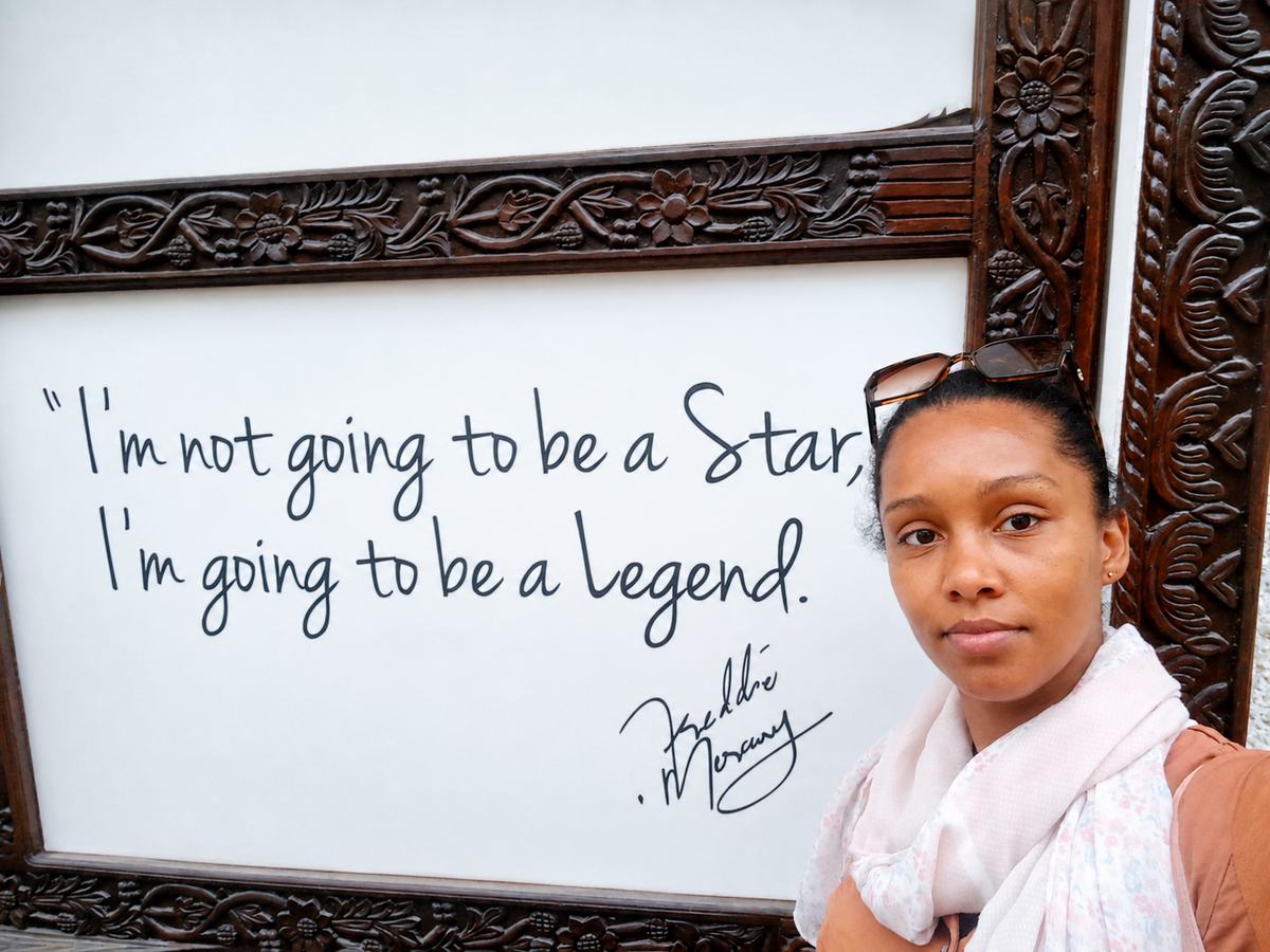 Nayma beside a framed Muhammad Ali quote about becoming a legend