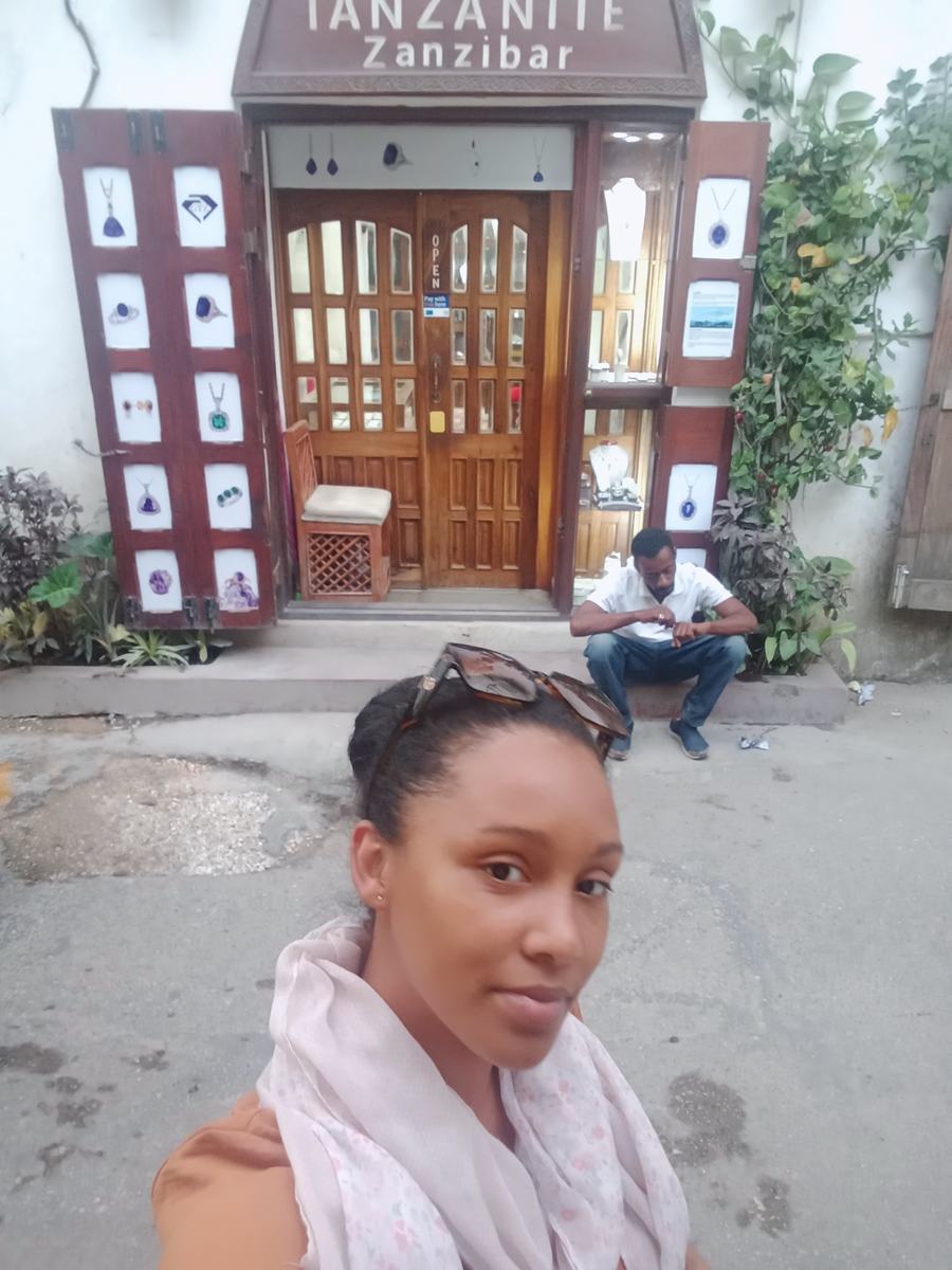 Nayma outside a Zanzibar doorway during her time in Tanzania